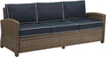 Brown Wicker Outdoor Sofa with Navy Cushions for Comfort